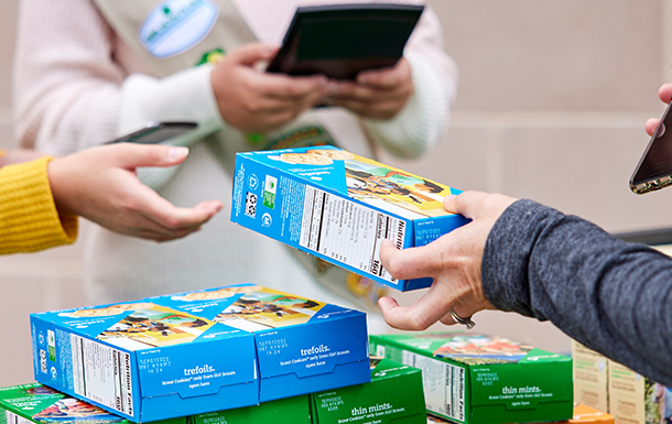 girl scout selling cookies