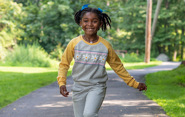 young girl outside smiling